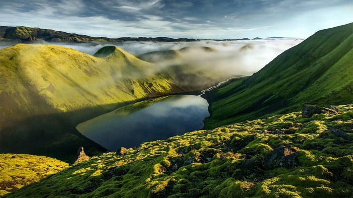 Misty valley with a lake in Iceland