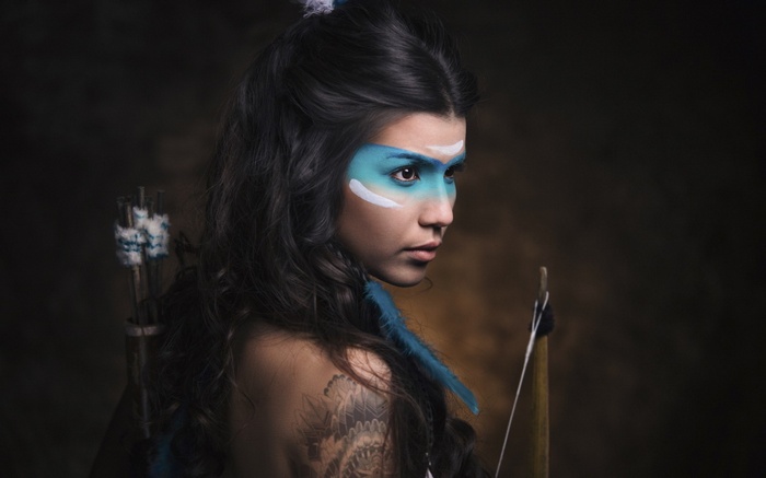Woman with face paint and bow
