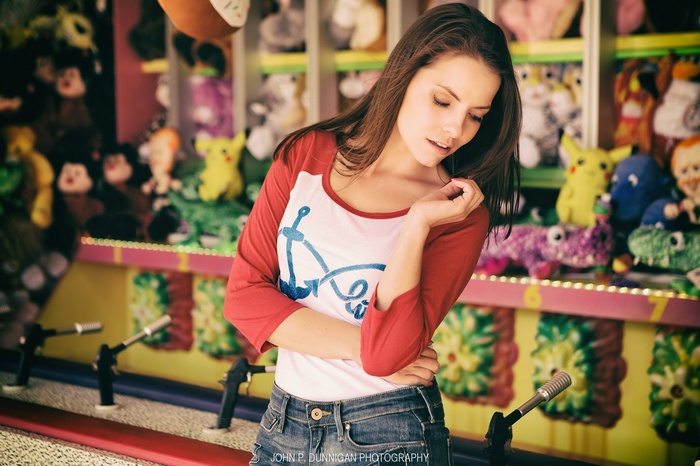 Brunette woman in jeans at a carnival game