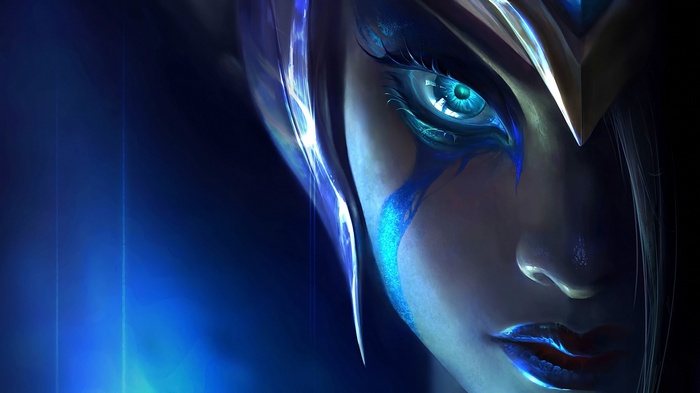 Close-up of a woman's face with blue markings
