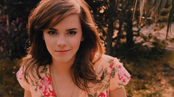 Emma Watson smiling in a floral dress