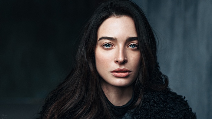 Portrait of a woman with dark hair and blue eyes