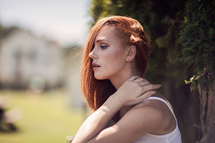Redhead woman with freckles in profile