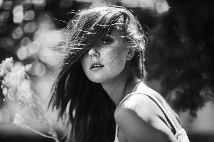 Monochrome portrait of Kyra Karmichael with hair in face