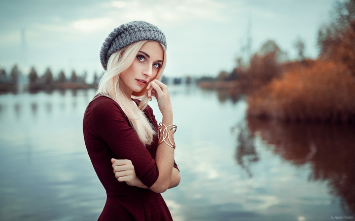Woman in a hat and dress by the river