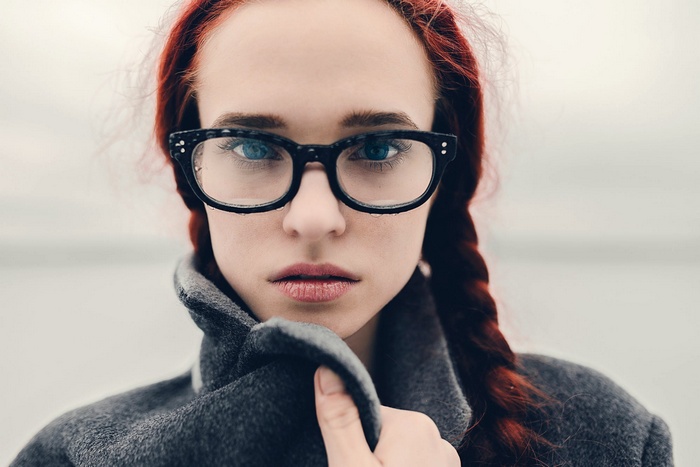 Portrait of a woman with red hair and glasses