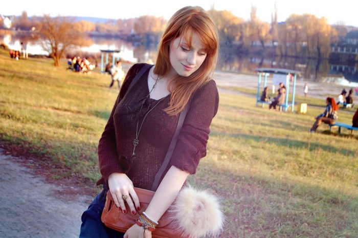 Alina Kovalenko with red hair outdoors by the water