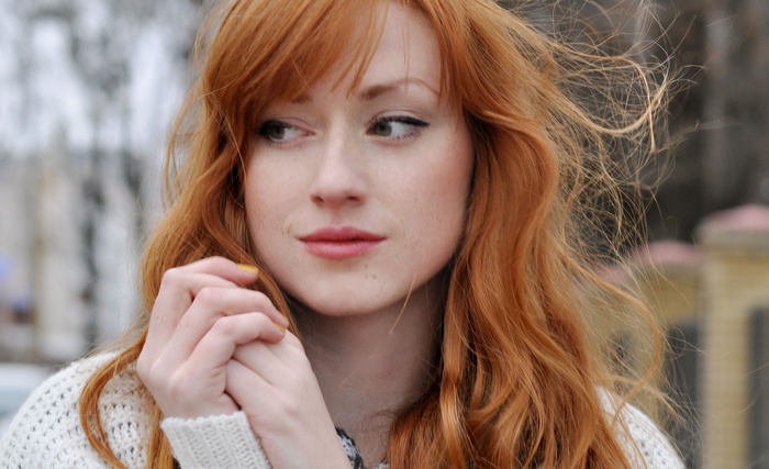Alina Kovalenko with red hair looking away