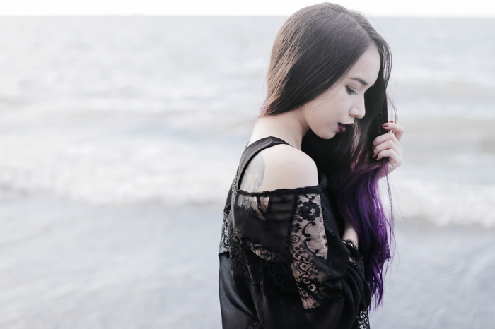 Woman with purple hair on the beach