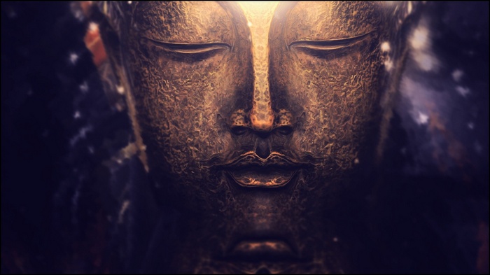 Close-up of a golden Buddha statue with bokeh background