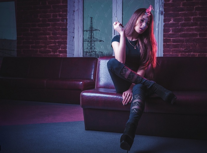 Woman smoking on a couch