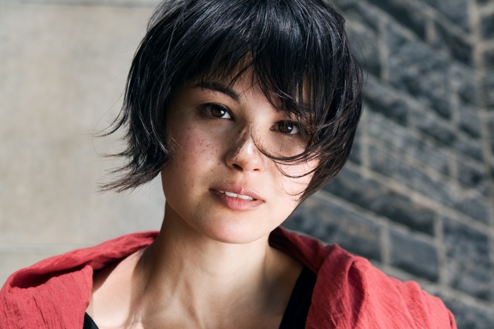 Woman with short black hair and freckles