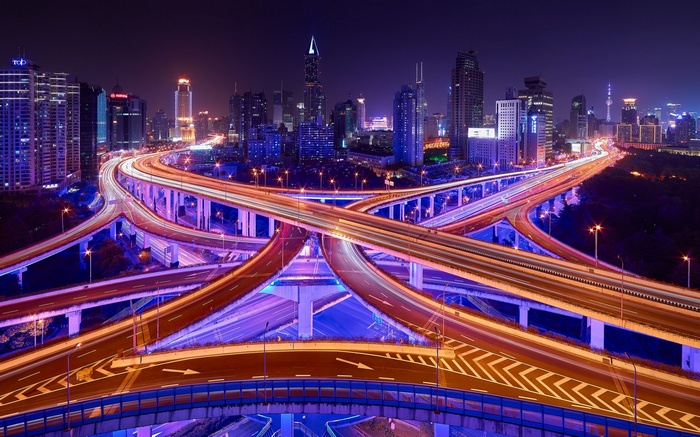 Shanghai nighttime cityscape with illuminated highway interchange