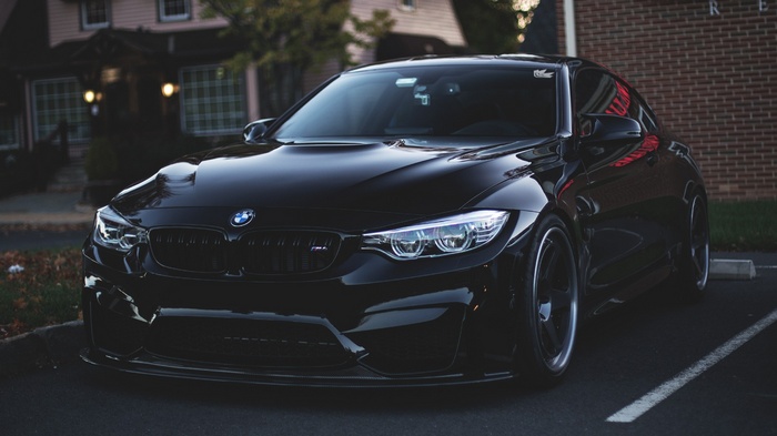 Black BMW M4 parked in a parking lot