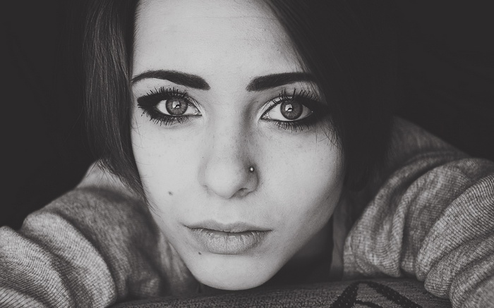 Woman with pierced nose looking at viewer