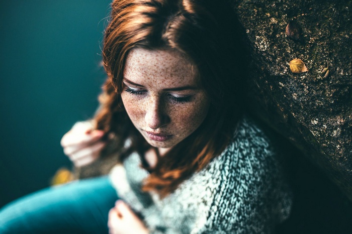 Portrait of a young woman with freckles