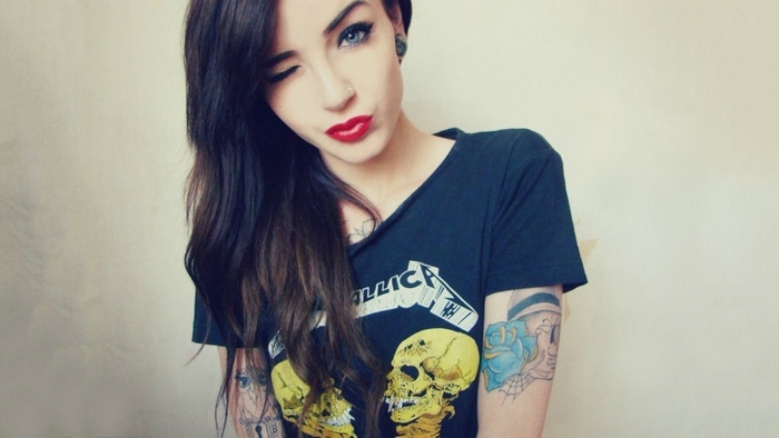 Woman with tattoos winks