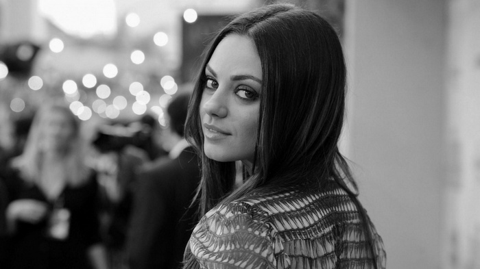Mila Kunis looking over her shoulder