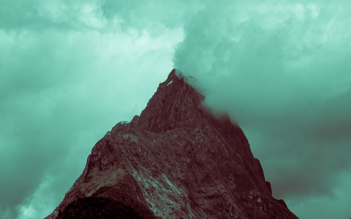 Jagged mountain peak shrouded in mist