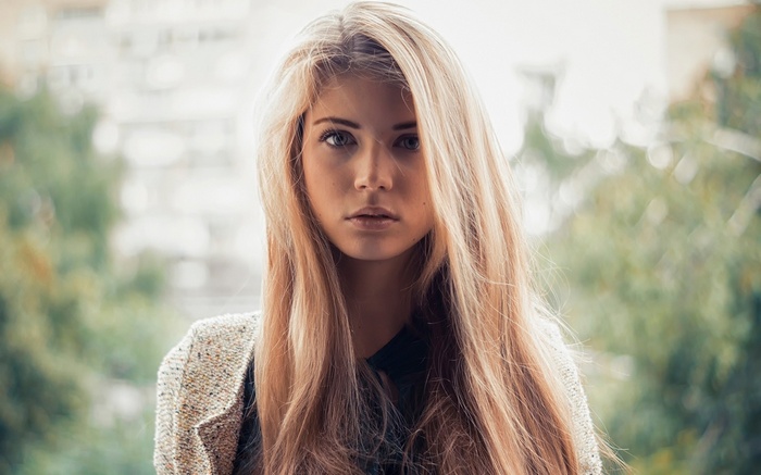 Blonde woman with long hair looking at viewer