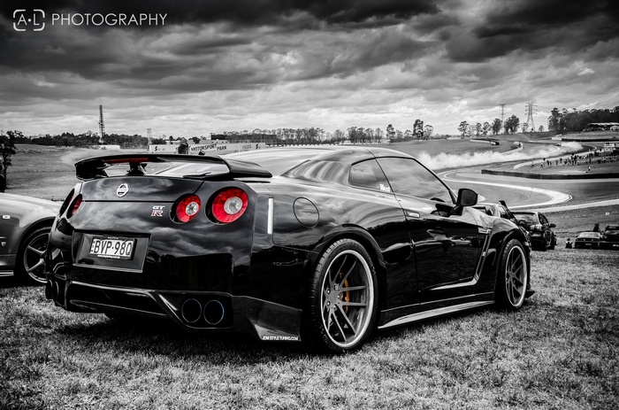 Black Nissan GT-R R35 on a grassy field