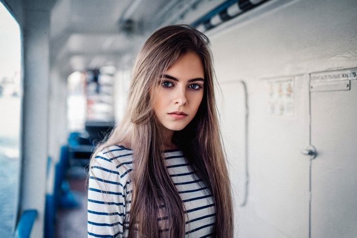 Young woman with long brown hair on a boat