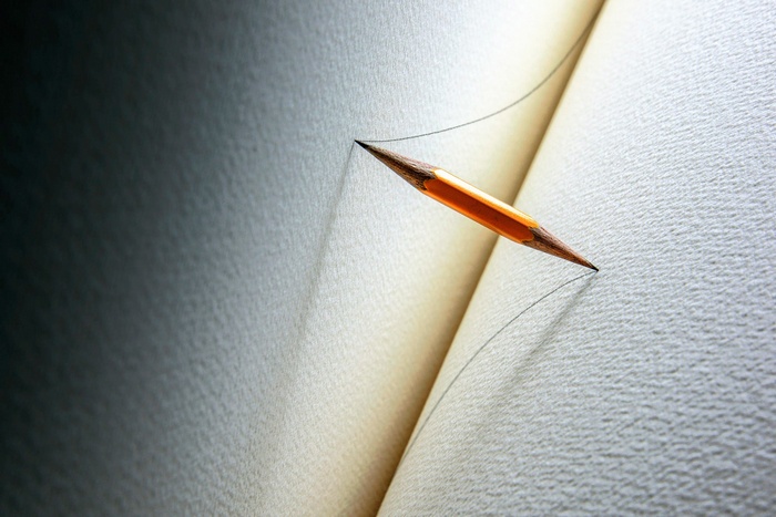 Pencil drawing a line on paper