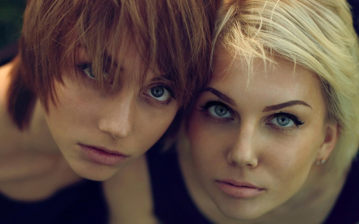 Two women, one blonde and one brunette, close-up portrait