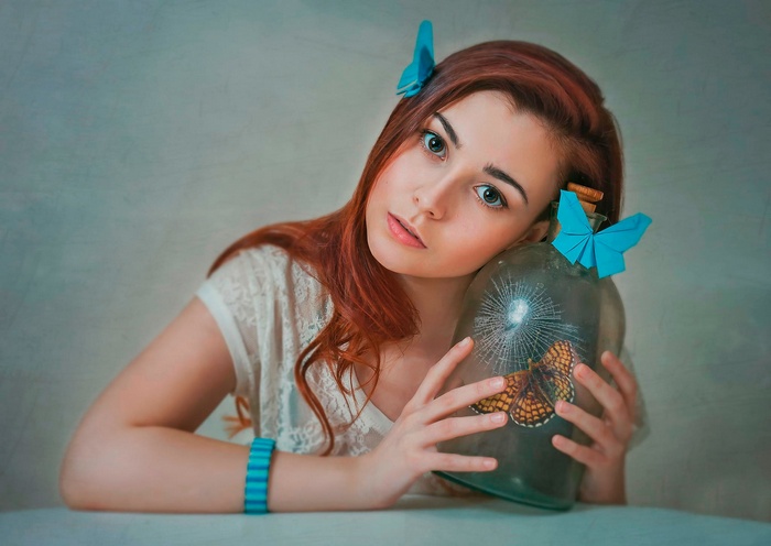Redhead woman with origami butterflies and a jar