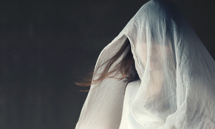 Asian woman hiding face with white cloth