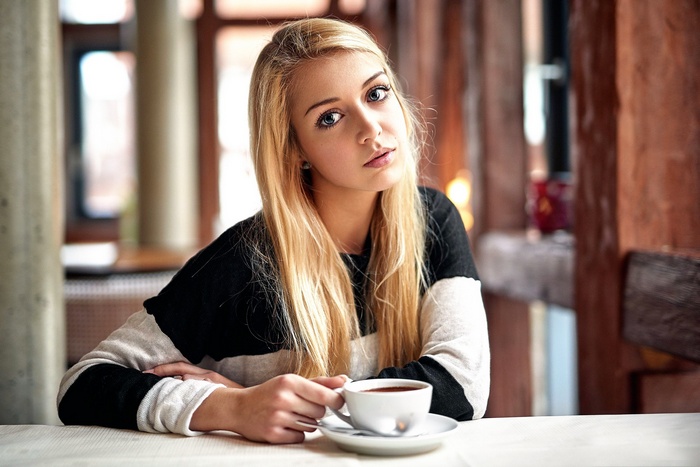 Young blonde woman with a cup of coffee