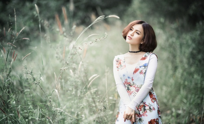 Asian woman in a floral dress in a field