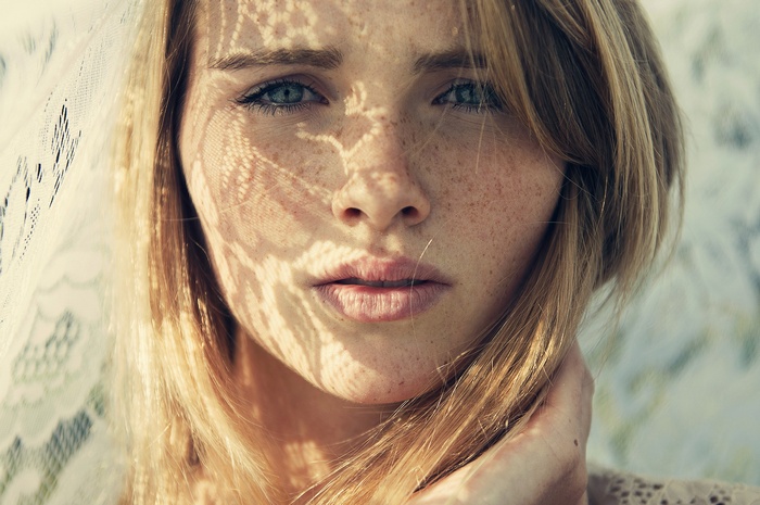 Woman with freckles and blue eyes