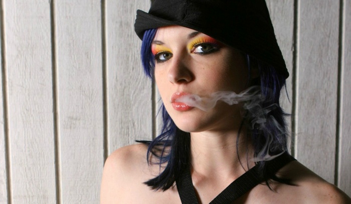 Stoya smoking with blue hair and colorful makeup
