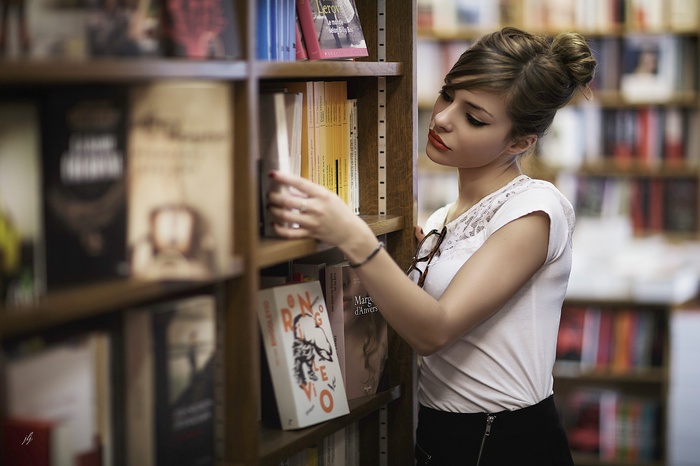 Woman browsing books in a library