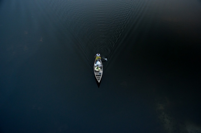 Two people in a boat on dark water