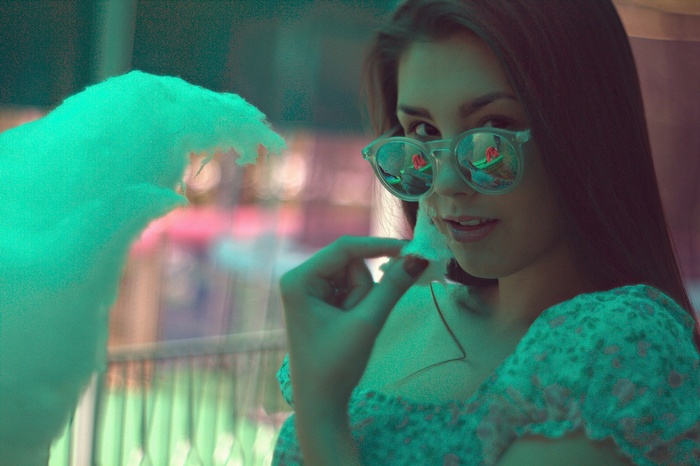 Woman in sunglasses eating cotton candy