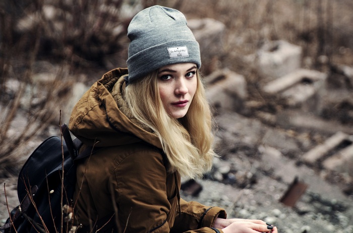 Woman with blonde hair wearing a beanie and jacket