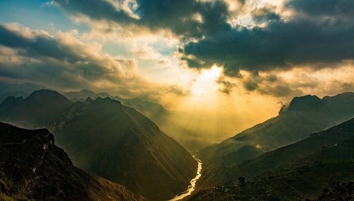 Sun rays over mountains and river in Vietnam