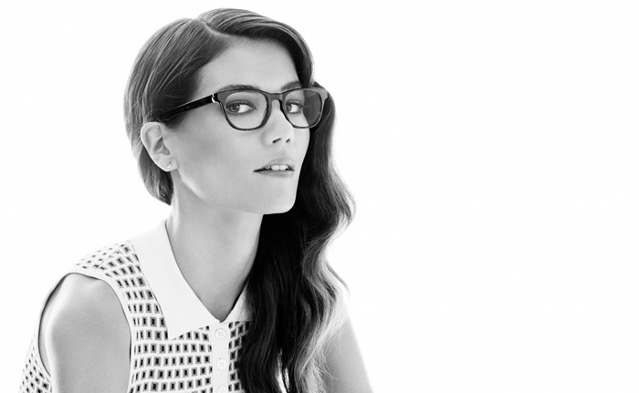 Woman wearing glasses and a patterned dress