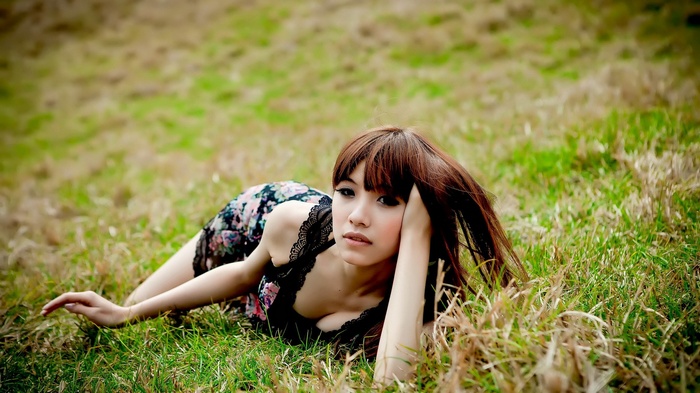 brunette, long hair, field, women outdoors, Asian, grass, cleavage, depth of field, lying on front, women, bare shoulders, hands in hair, looking at viewer, nature, black dress, model