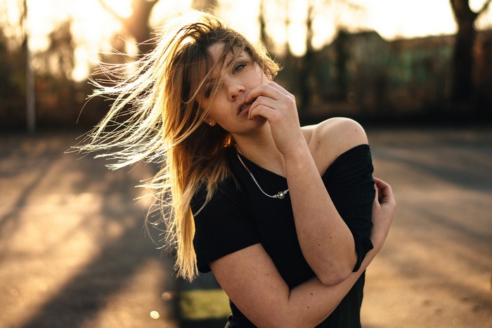 Woman with blonde hair in black top
