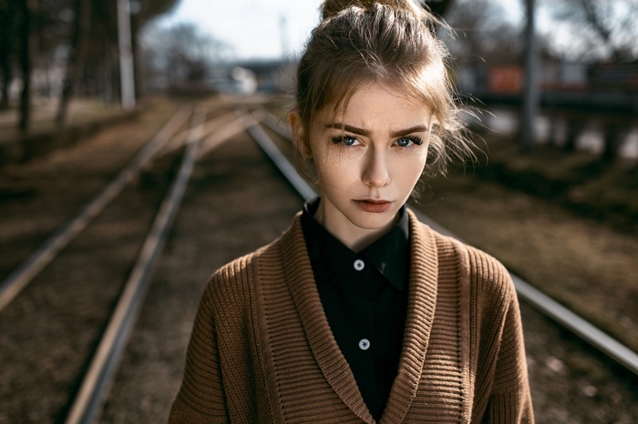 Woman with blonde hair on railway tracks