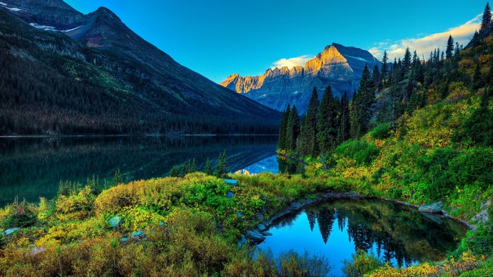 Mountain lake with evergreen trees and colorful foliage