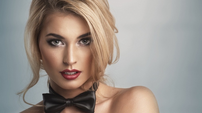 Blonde woman with red lipstick and bow-tie
