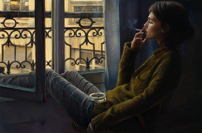 Woman smoking by a window