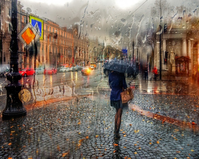 Woman with umbrella on a rainy city street
