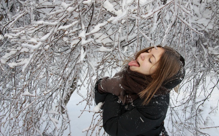Woman sticking her tongue out in the snow