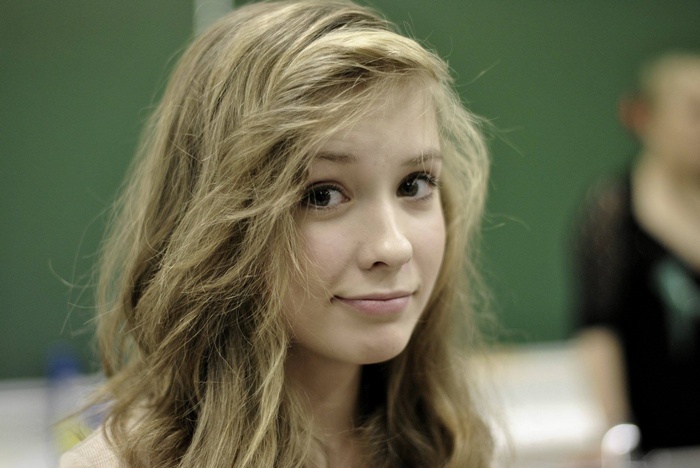 Young blonde woman looking at the viewer