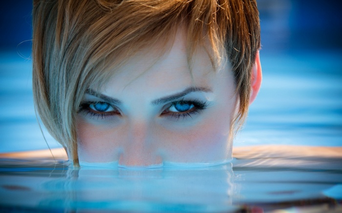 Woman with blue eyes in a swimming pool